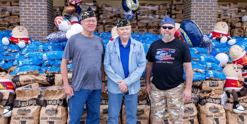 Volunteers from VFW Post 2750 stand in front of a record-breaking display built from 250,000 Idaho potatoes during a celebration of America’s 250th anniversary